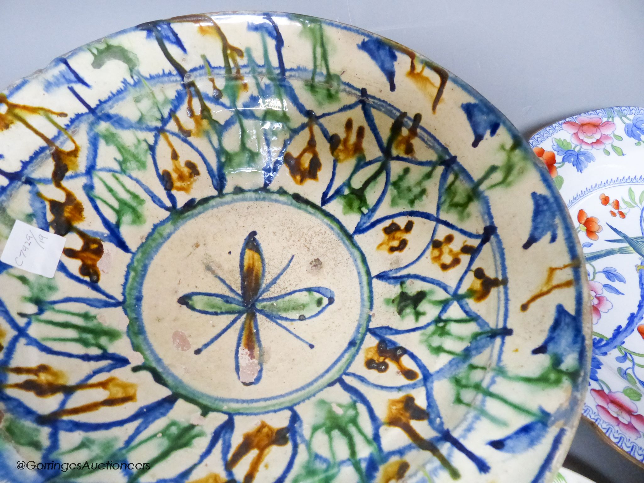 A Moroccan terracotta dish, an Ironstone dish, a green and white leaf dish, largest 30cm